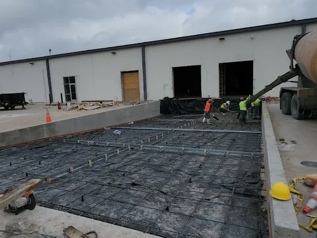 Commercial slab pour with rebar at a warehouse job site